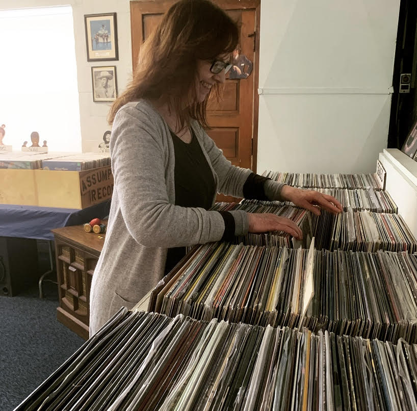 Woman looking through bins of albums