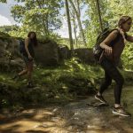 two women jumping over a stream surrounded by rocks and trees Fairmont waterfall Bird banding Bird banding west virginia Saw whet owls west virginia 