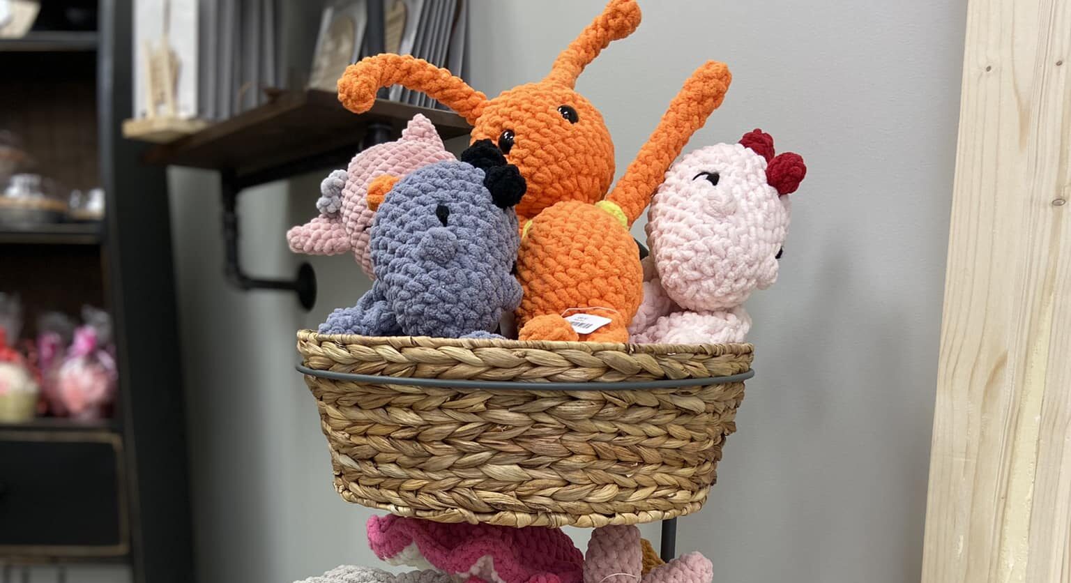 three tiered basket with crocheted stuffed animals